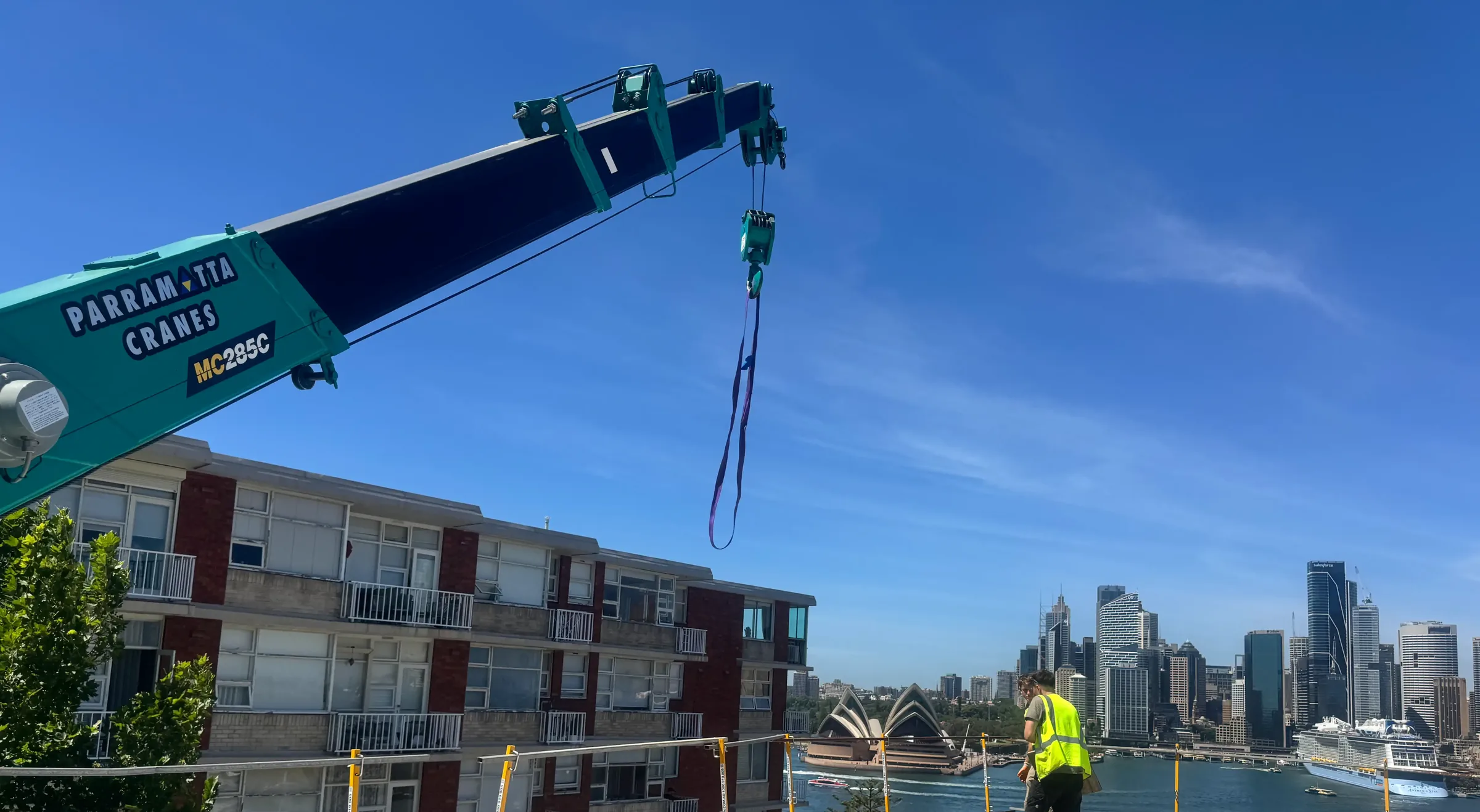 Parramatta Cranes Maeda 285 spider crane working on a Sydney rooftop with the Opera House and city skyline behind