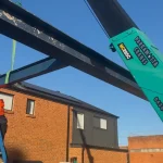 Maeda 285 lifting steel beams on a construction site in Sydney