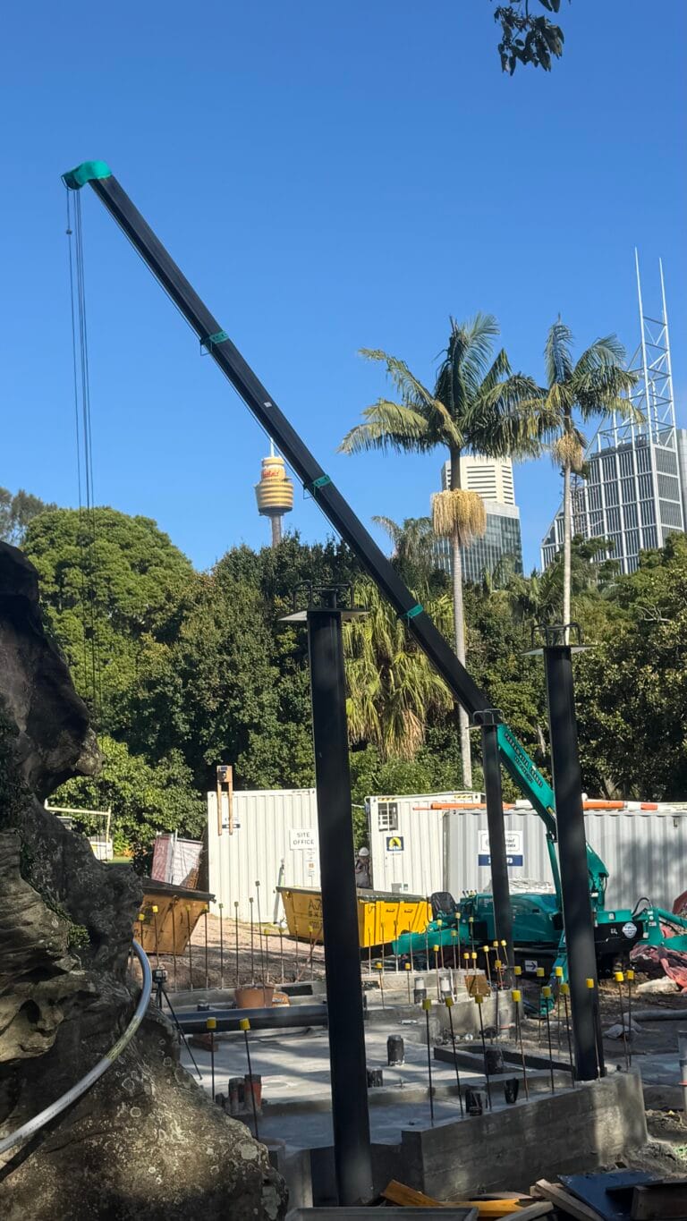 Maeda 305 mini crawler crane lifting structural steel on a restricted-access government site in Sydney